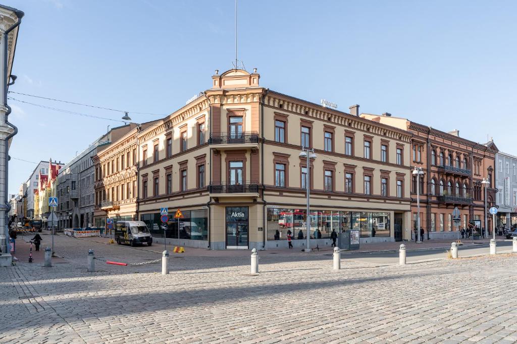 a large building on a street in a city at 2ndhomes Tampere Luxurious "Keskustori" Apartment - Private Sauna & Great Location in a Historical Building in Tampere