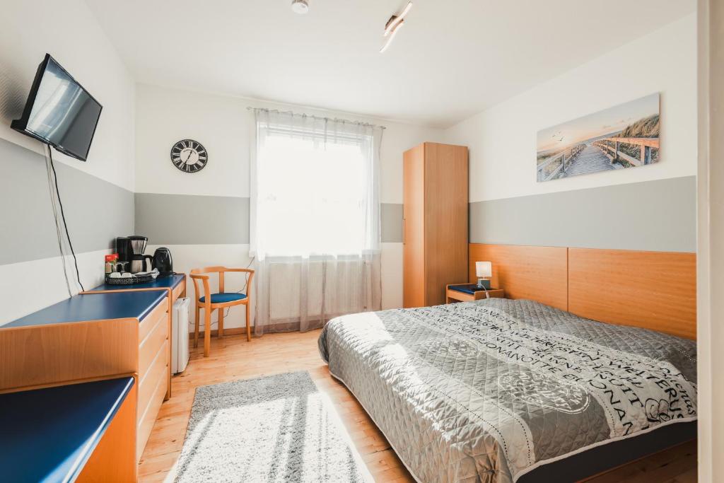 a hotel room with a bed and a television at Stral-Sund in Stralsund