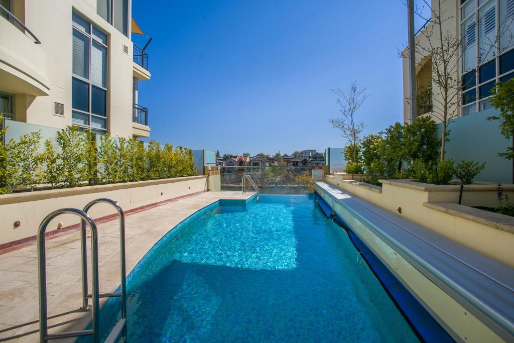 a swimming pool in the middle of a building at Royal Respite Spacious Apartment - Walk to Restaurants in Perth