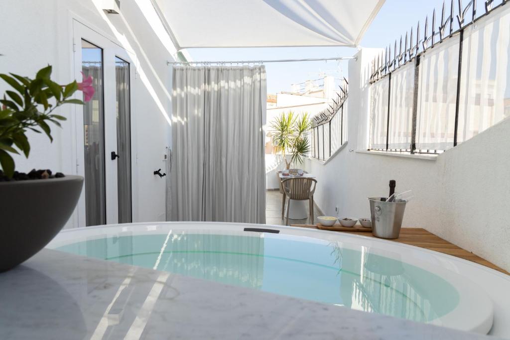 a room with a swimming pool in a house at Peonia Boutique Apartments in Palermo