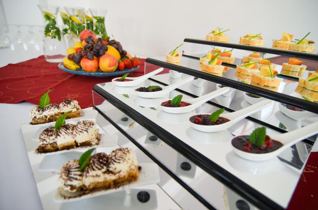 a buffet of food with desserts and fruit at Hotel Galant Lednice in Lednice