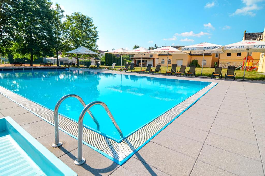 a large swimming pool with a metal stairway leading into it at Hotel Galant Lednice in Lednice