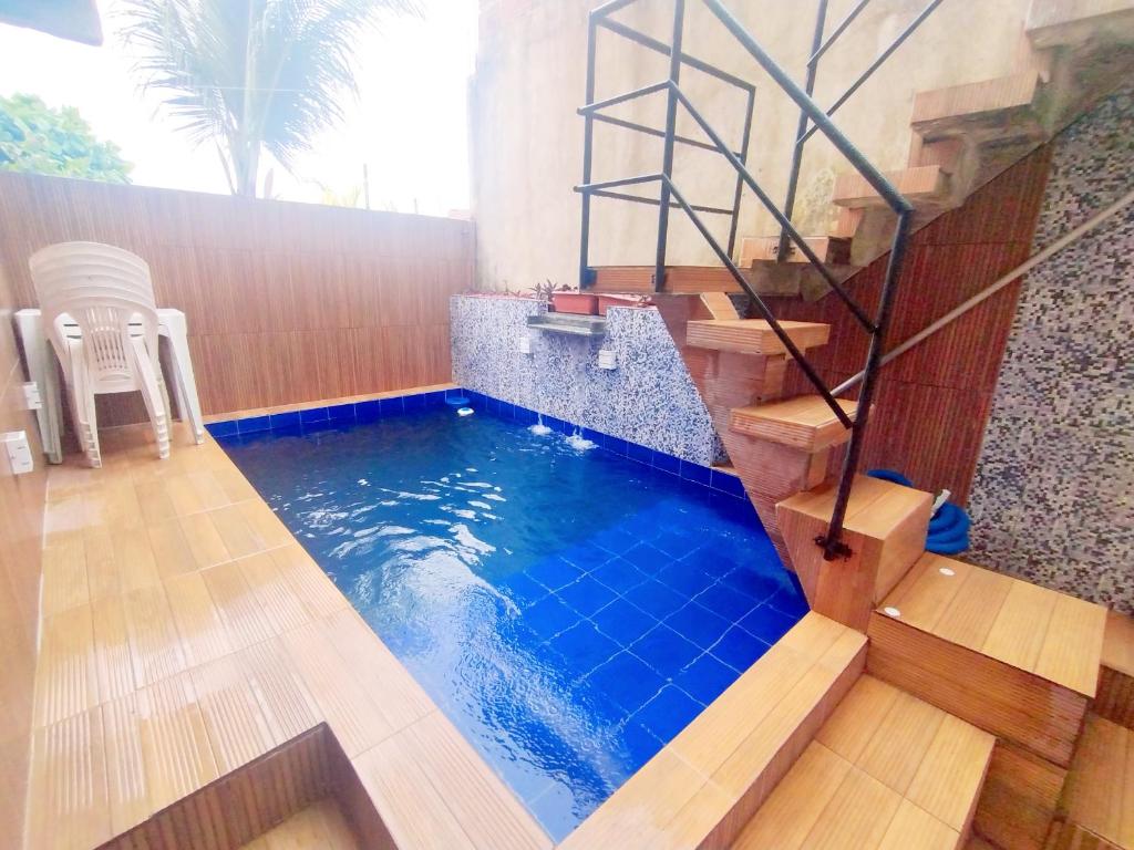 a swimming pool with a stair in a house at Casa de praia Rocha Alves em Porto de Galinhas in Porto De Galinhas