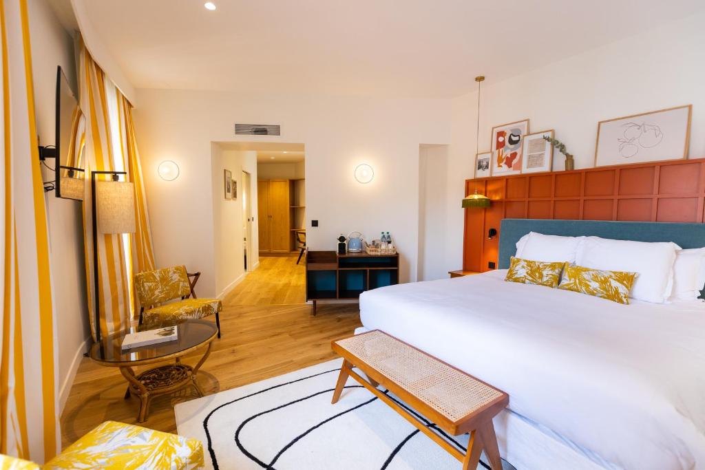 a hotel room with a large bed and a living room at Maison Durante in Nice