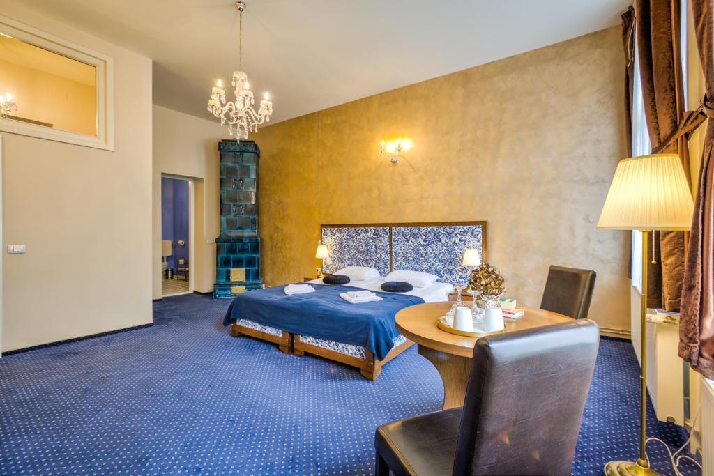 a bedroom with a bed and a table in a room at Residence Central Annapolis in Braşov