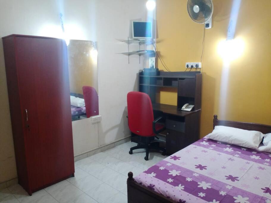 1 dormitorio con cama, escritorio y ordenador en Relaxing apartment l Revenla garden l en Matara