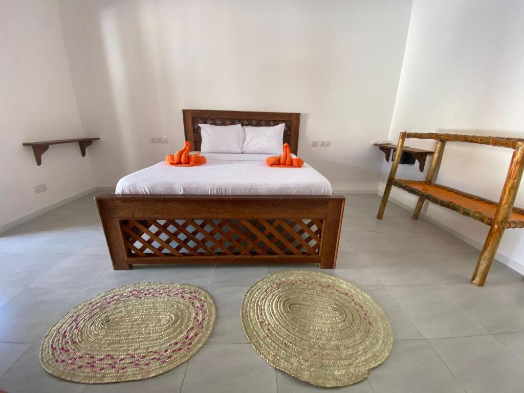 Postel nebo postele na pokoji v ubytování Amani Hotel Paje