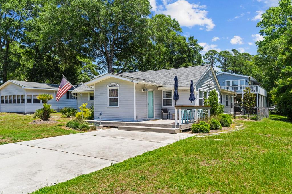 a house with two american flags in front of it at Gone Intracoastal in Ocean Isle Beach