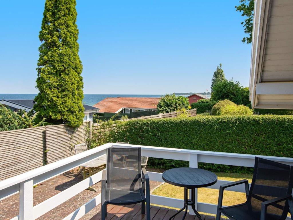 a patio with two chairs and a table on a balcony at 6 person holiday home in Str by in Strøby