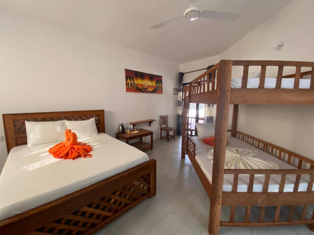 Postel nebo postele na pokoji v ubytování Amani Hotel Paje
