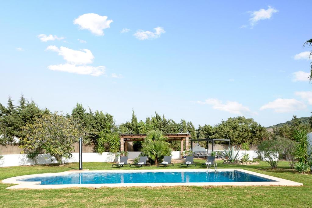 a swimming pool in a yard with trees at Villalaluna in Vejer de la Frontera