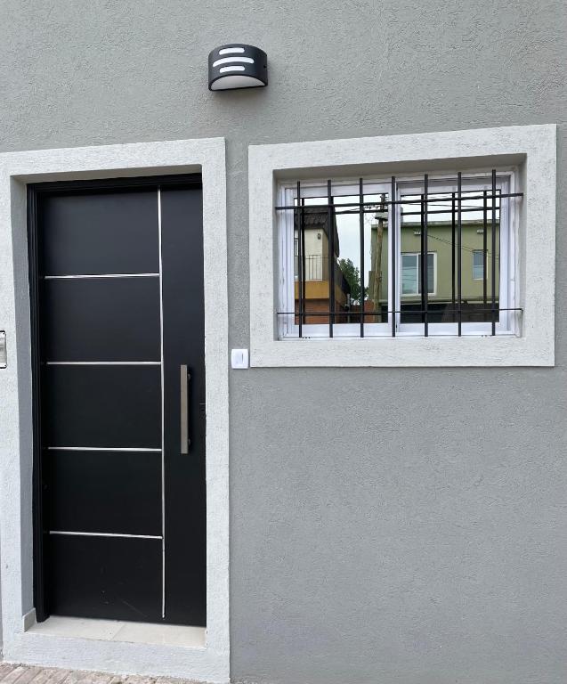 a door and a window on the side of a building at Dto III Temperley in Temperley