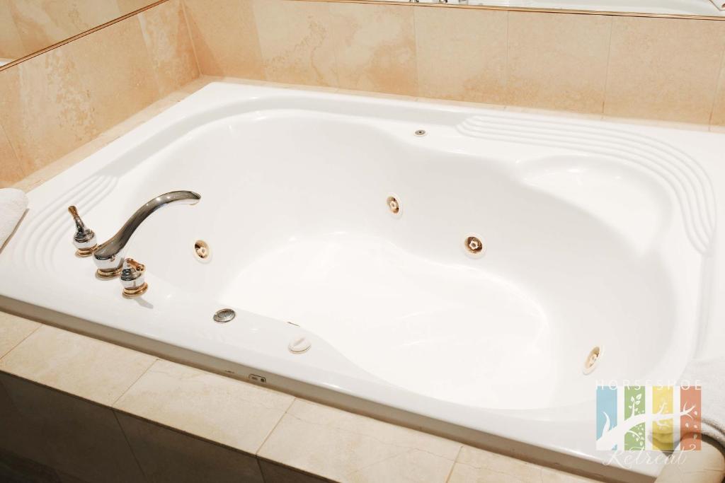 a white bath tub in a bathroom at Horseshoe Retreat in Edgar