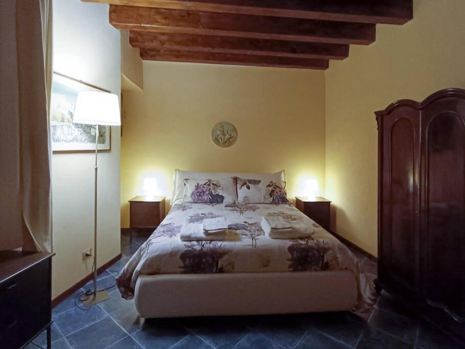 a bedroom with a large bed with two lamps at Casa all'Annunziata in Termini Imerese