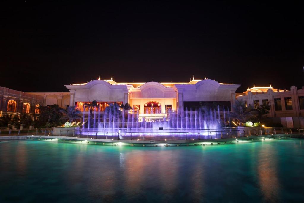 a large building with a fountain at night at InterContinental Grand Ho Tram in Ho Tram