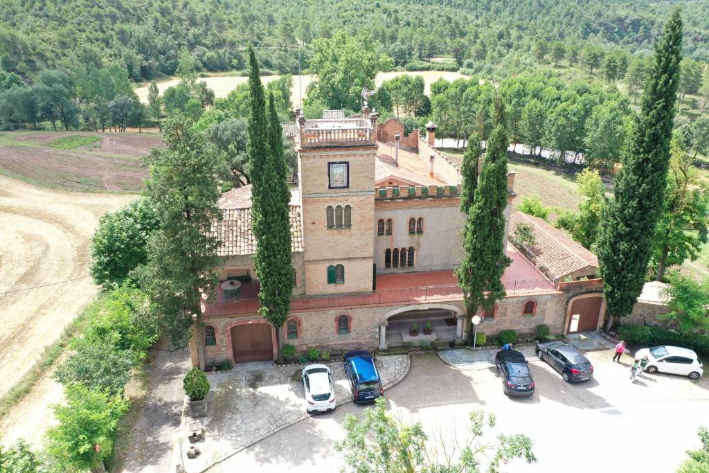 una vista aérea de un edificio con coches aparcados en un aparcamiento en La Vila d'Argençola - Apartamentos, en Castellnou de Bages