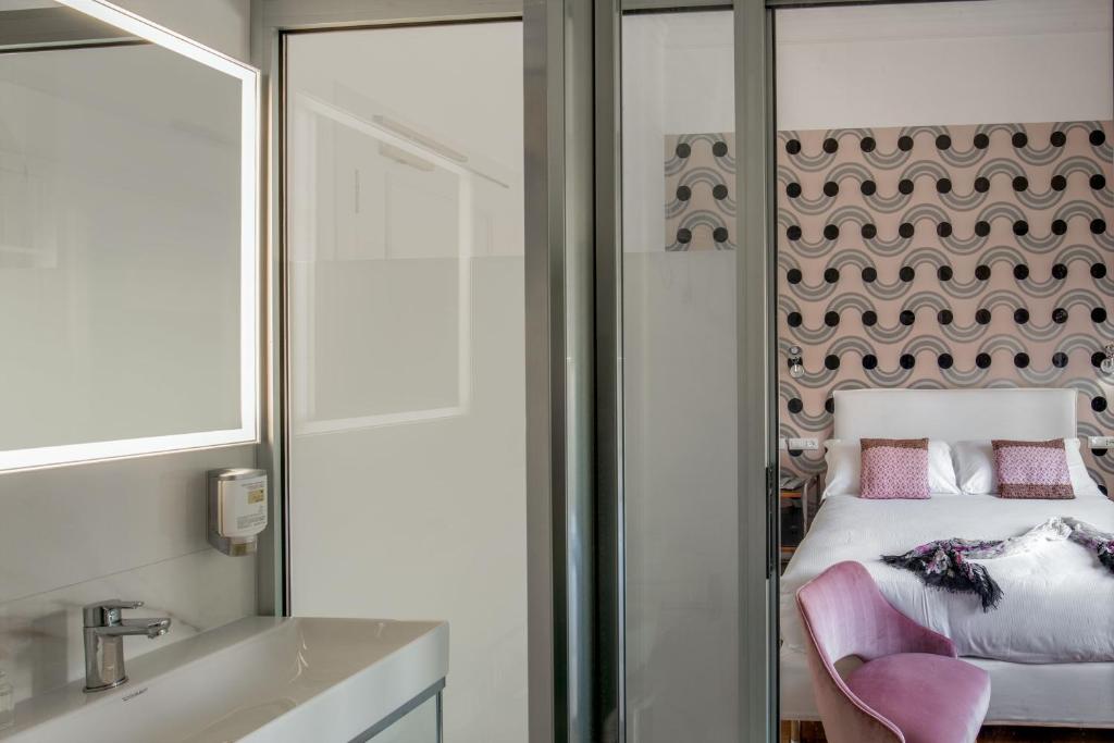 Postel nebo postele na pokoji v ubytování Hotel Emona Aquaeductus