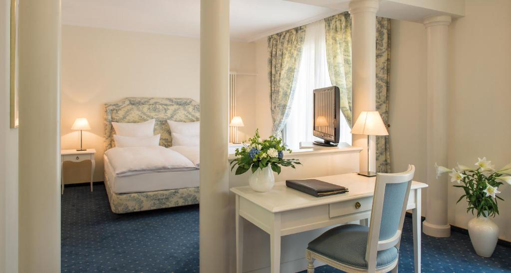 Ein Bett oder Betten in einem Zimmer der Unterkunft Victor's Residenz-Hotel Saarbrücken