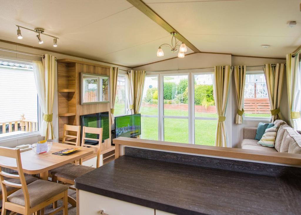 a tiny house with a kitchen and a living room at Ocean Heights Leisure Park in New Quay