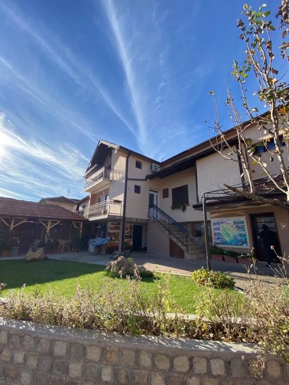 a house with a lawn in front of it at Vila Mišur in Pirot