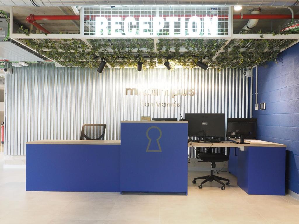 an office with a blue desk with a symbol on it at Micampus San Mamés Students Residence in Bilbao