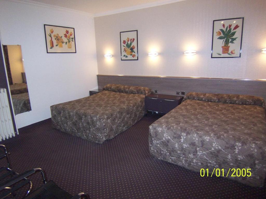 Postel nebo postele na pokoji v ubytování Hôtel Du Stade