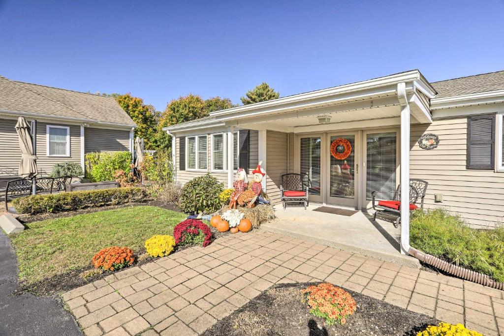 a house with a porch with pumpkins in the yard at Tranquil Swansea Retreat with Fire Pit and Grill! in Swansea