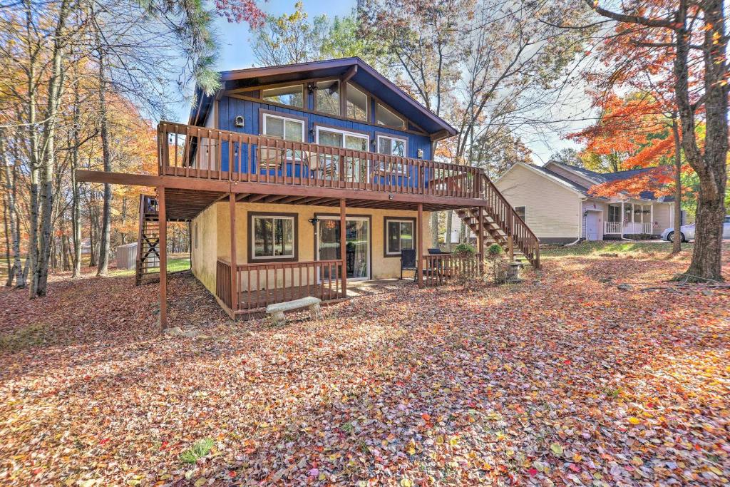 a house with a large deck in the woods at Less Than 7 Mi to Slopes Inviting Pocono Mtn Retreat! in Albrightsville