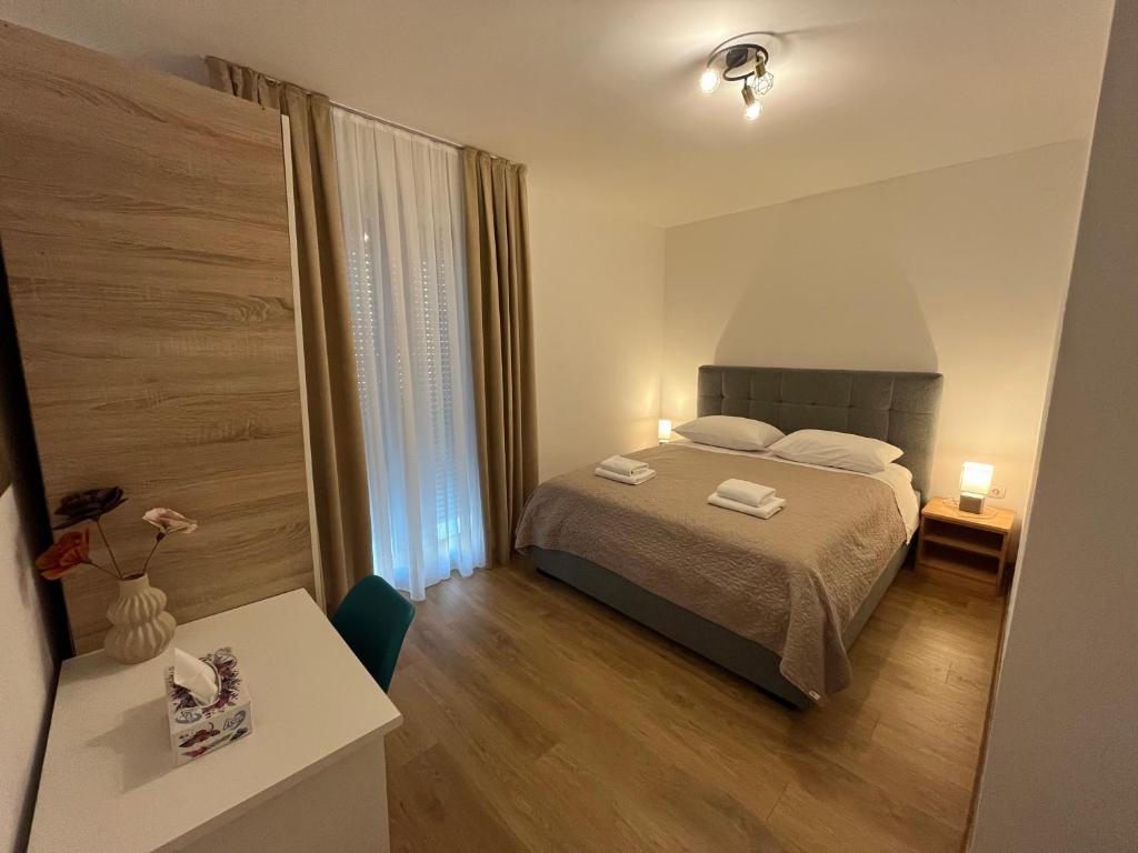 a bedroom with a bed with two towels on it at Apartment Renata in Zadar