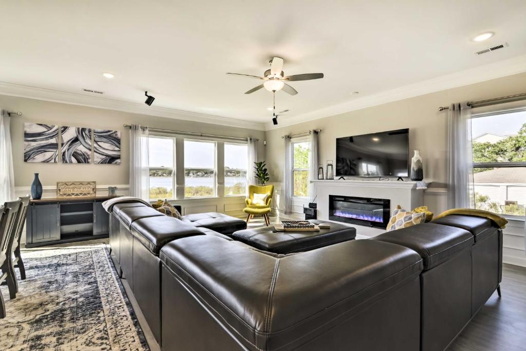 a large living room with a leather couch at Waterfront Paradise with Deck about half Mi to Beach in North Camellia Acres