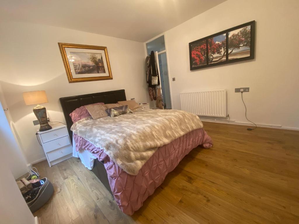 a bedroom with a large bed and a wooden floor at Hidden gem in Central London Oval - Elephant and Castle in London