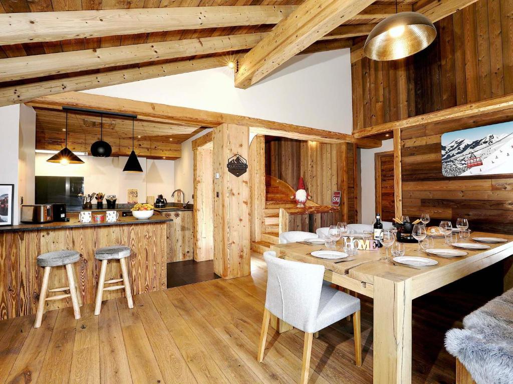 ein Esszimmer mit Tisch und eine Küche in der Unterkunft Chalet raffiné à La Tania, Courchevel - 10/12 pers, spa, sauna, billard, ski-in/ski-out - FR-1-575-20 in Courchevel