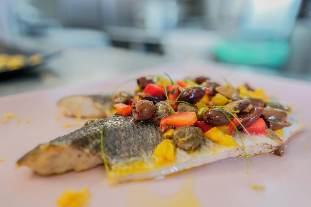 a piece of pizza with meat and vegetables on a table at Il Monastero in Geremèas