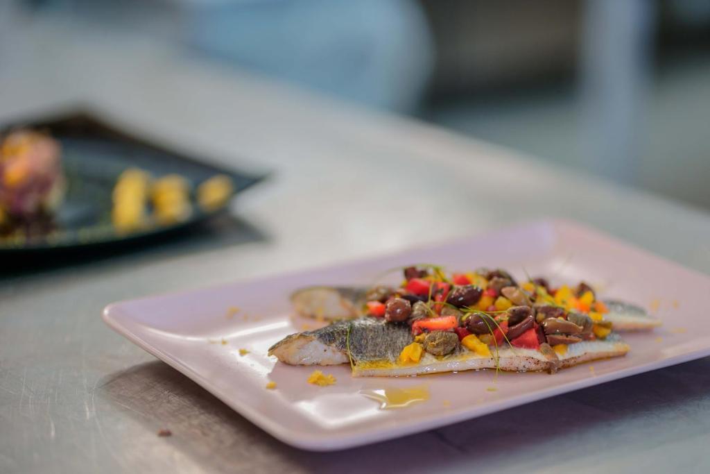 a white plate with food on a table at Il Monastero in Geremèas