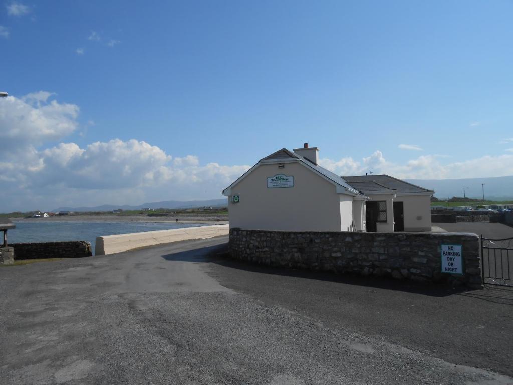 a building next to a body of water at The Waters Edge in Aughris
