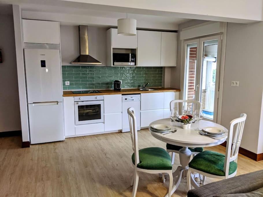 a kitchen with a table and chairs in a room at Apartamento Sanfuentes Bat in Sanfuentes