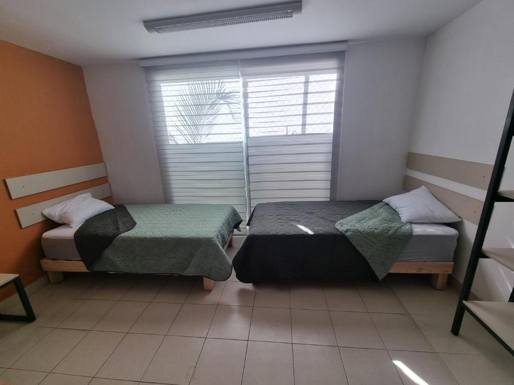 Postel nebo postele na pokoji v ubytování Residencia Ximatario
