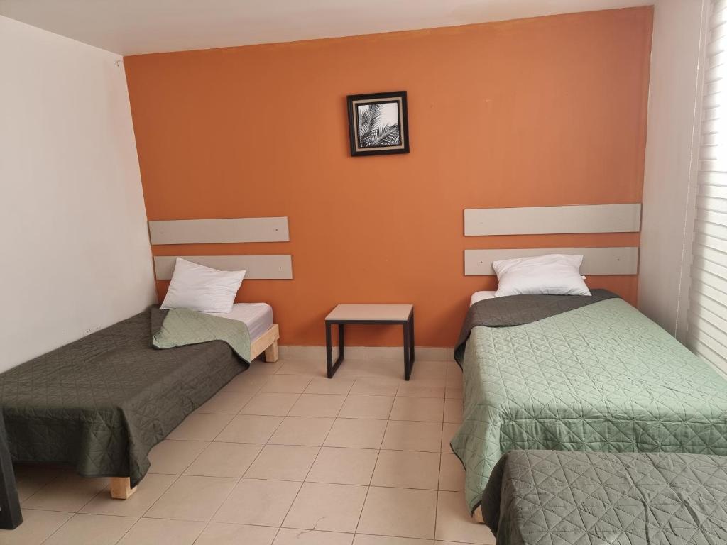 Postel nebo postele na pokoji v ubytování Residencia Ximatario