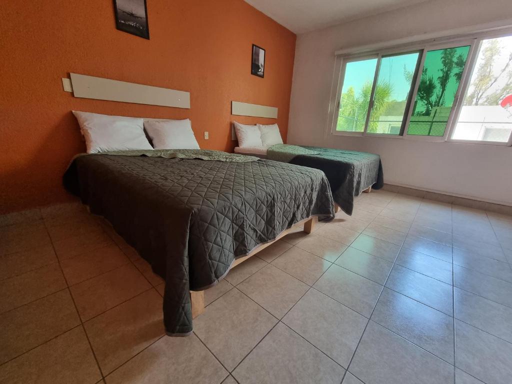 Postel nebo postele na pokoji v ubytování Residencia Ximatario
