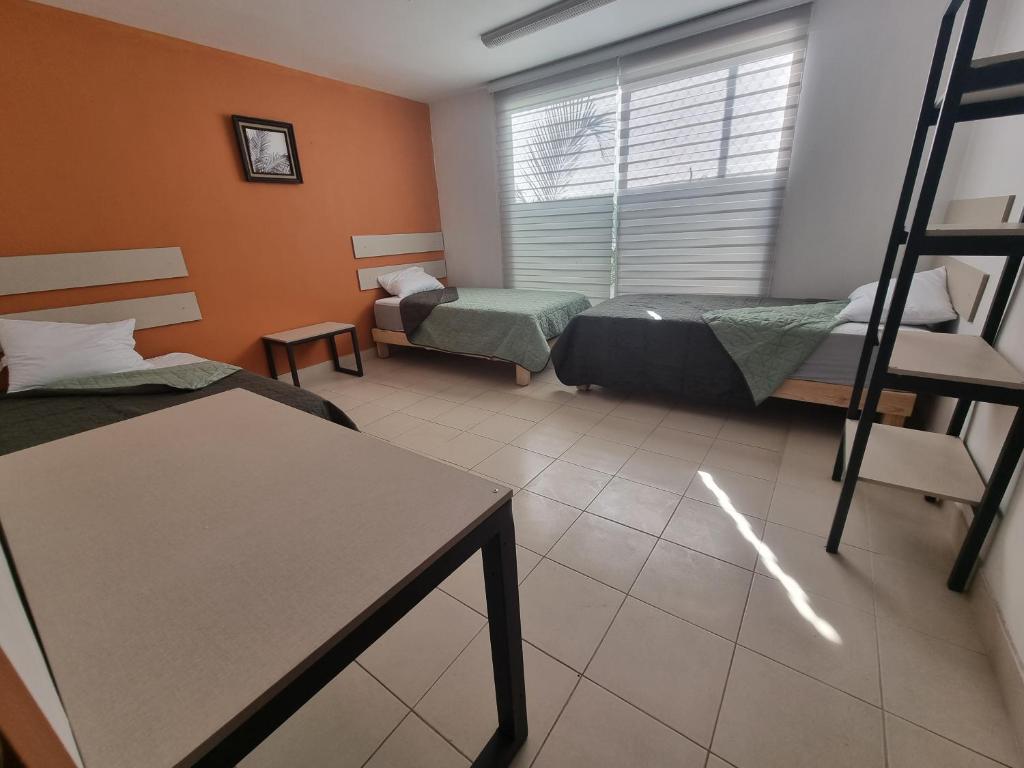 Postel nebo postele na pokoji v ubytování Residencia Ximatario