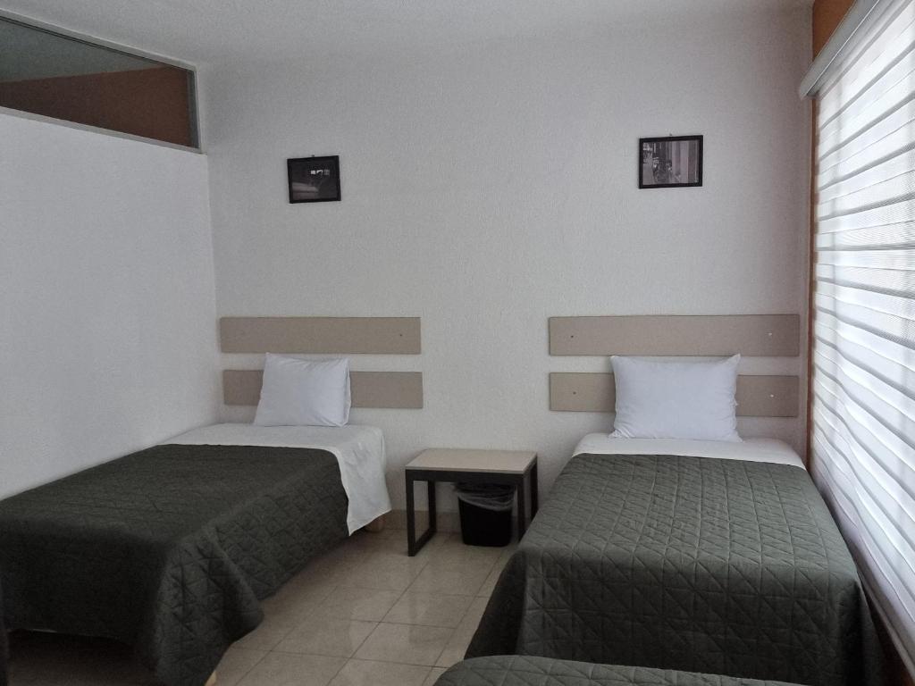 Postel nebo postele na pokoji v ubytování Residencia Ximatario