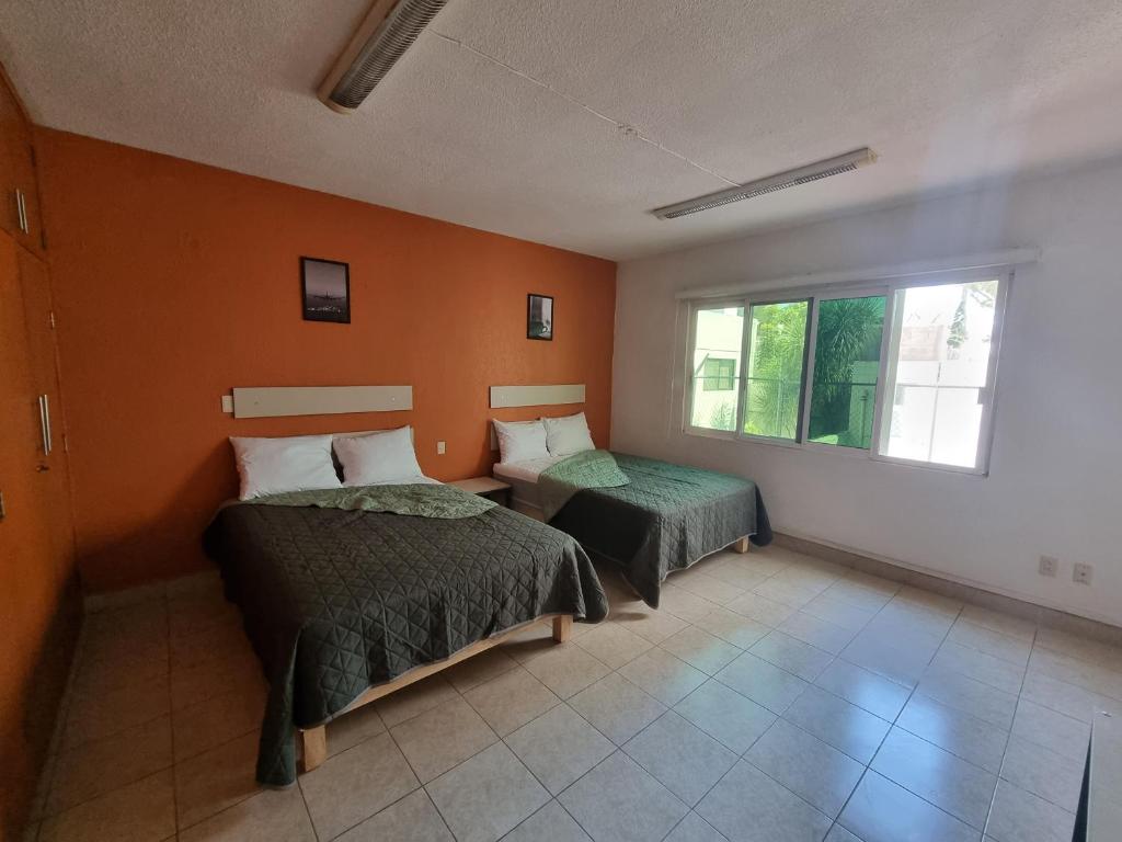 Postel nebo postele na pokoji v ubytování Residencia Ximatario