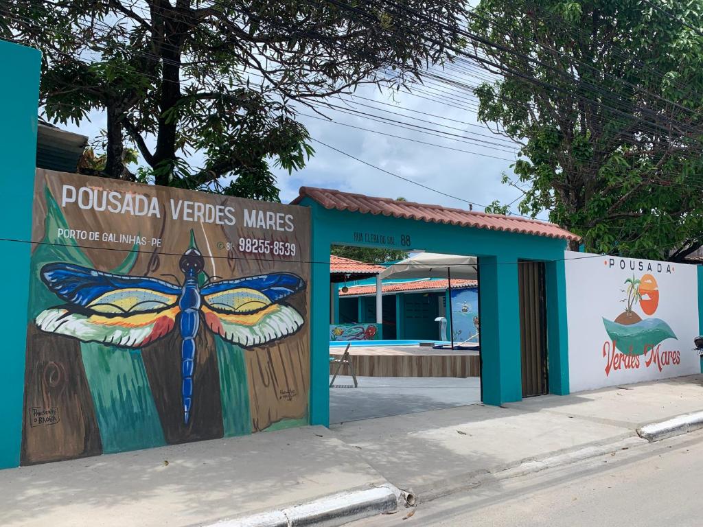 a building with a painting of a butterfly on it at Pousada Verdes Mares Porto De Galinhas in Porto De Galinhas