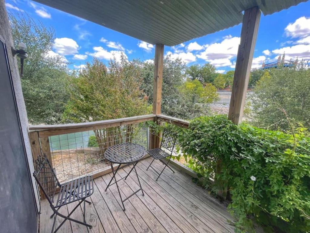 a patio with two chairs and a table on a deck at Comal River Condo 373 in New Braunfels