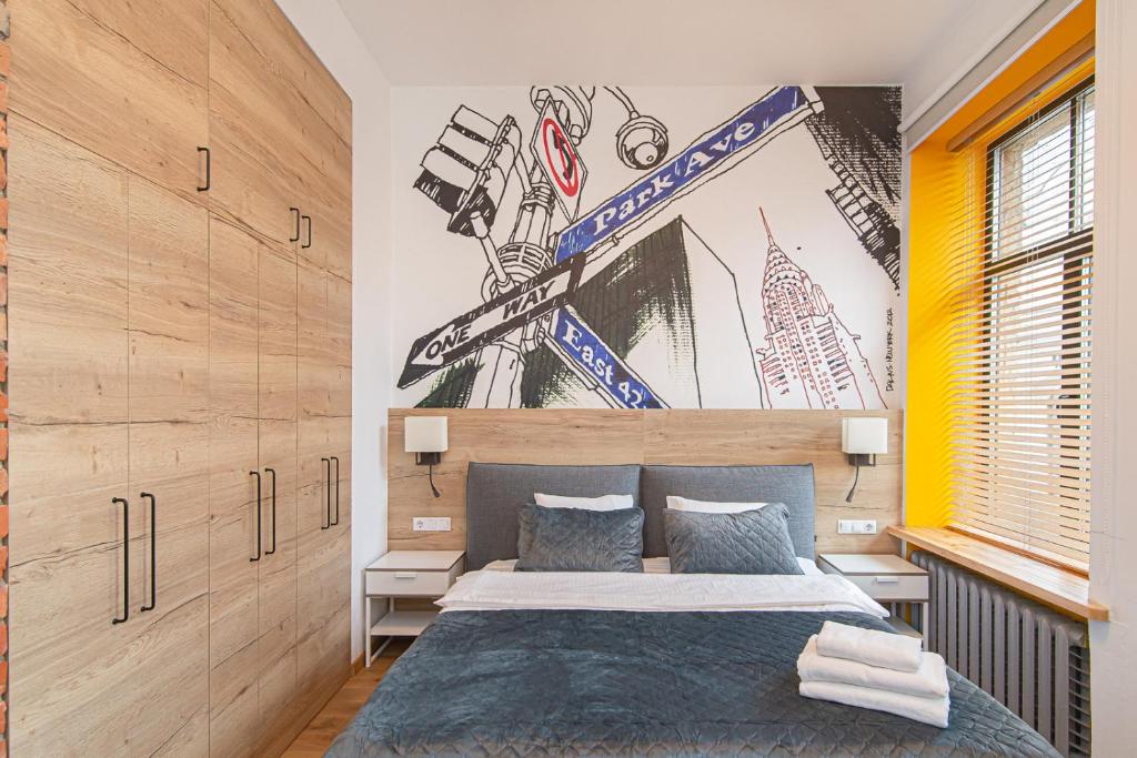 a bedroom with a bed and a wall with skis on it at Modern Vilnius Old Town apartment with free parking in Vilnius