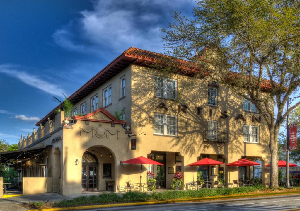 a building with red umbrellas in front of it at Artisan Downtown in DeLand