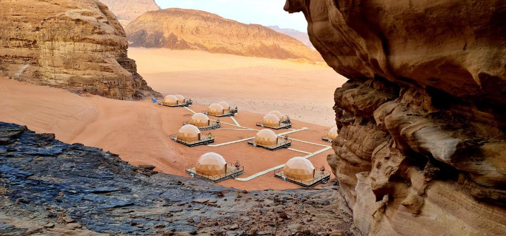 an aerial view of a desert with domes in the sand at Hasan Zawaideh luxury camp 2 in Wadi Rum