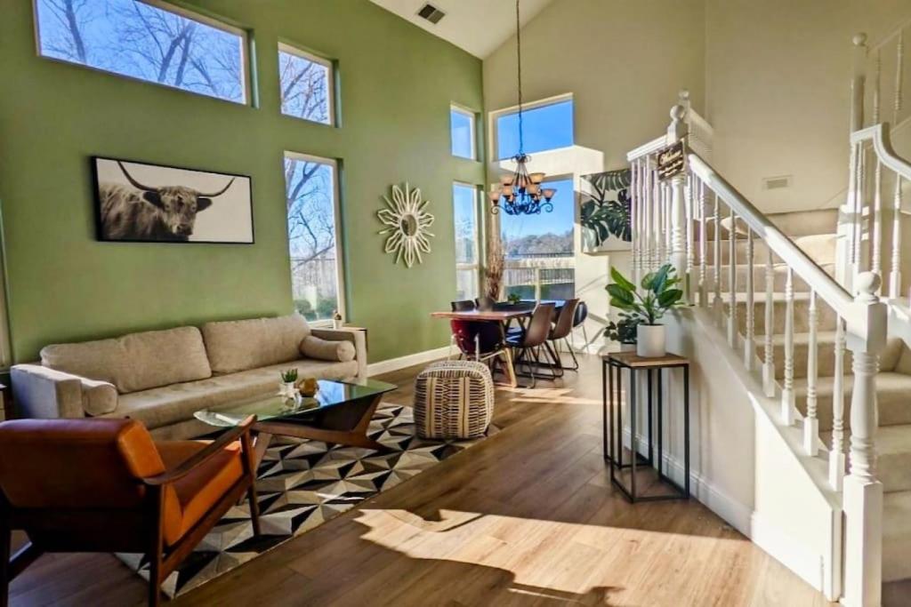 a living room with green walls and a couch at King Bed Quiet Home on Cul-de-Sac Hiking Trails in Roseville
