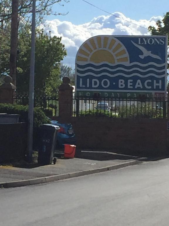 a sign for the loxons indio beach at 3 Bed Caravan Lido Beach in Prestatyn