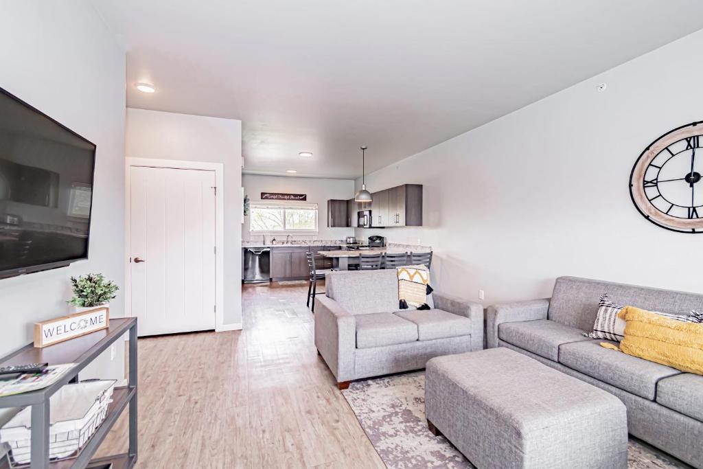 a living room with a couch and a table at Bringham's Mill Apartments Perfect for Groups Full Kitchen Gym and Free Parking in Rexburg